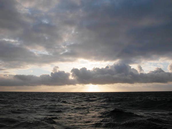 The early-morning orange horizon after a night of angry seas.