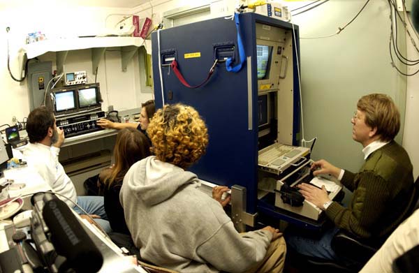 The benthic science team watches the monitors of the ROV's dive