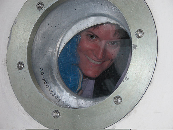 Doni peers out of a porthole in the aft chamber of the JSL II submersible