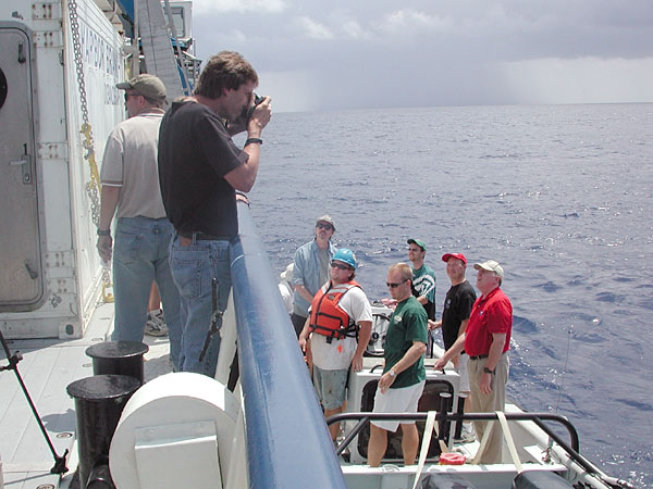 A boat picks up the Media crew