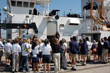 Students and teachers gather on the dock