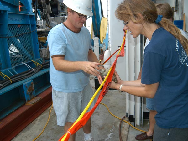 Peter Etnoyer from MCBI hands University of Oregon scientist Sandra Brooke a rock collected at Green Canyon.  