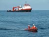 small boat launched from the Sonsub ship makes its way to the Ron Brown