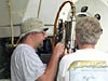 Technicians adjusting a devise on one of Alvin’s manipulator arms.