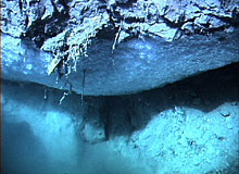 Methane gas hydrate forming below a rock overhang at the seafloor on the Blake Ridge diapir.