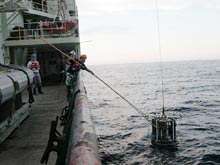 The CTD rosette is brought back on deck after having taken water samples and a profile of the water column.