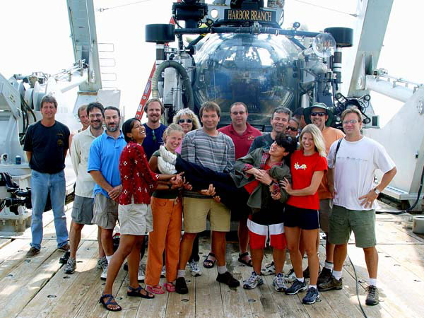 The Deep Scope mission team gather in front of the Johnson-Sea-Link submersible