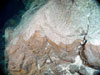 A contact between the lower basaltic and upper felsic ash units in the wall of the West Rota caldera.