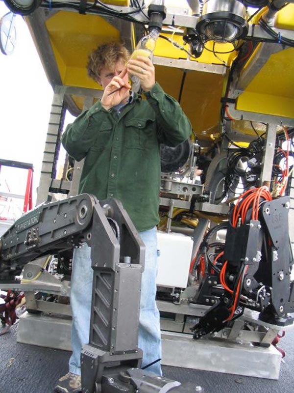 Inspecting hydraulic fluid from the ROV Hercules.