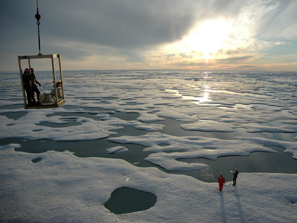  Scientists are lowered down onto Arctic ice in a 