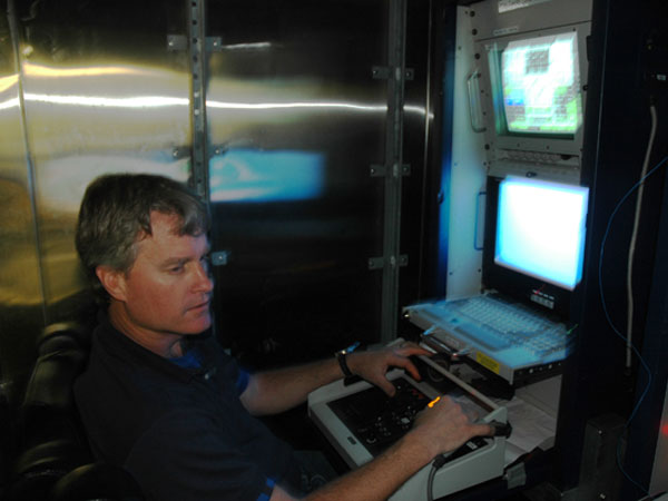 ROV pilot, Joe Caba, remotely operates the ROV from the ROV control room on board the ship.