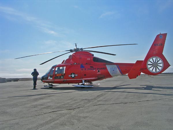 A US Coast Guard helicopter flies the equipment and scientists to the Coast Guard Cutter Healy which sits about 5 miles offshore.