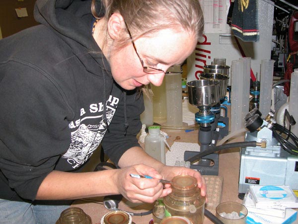 Research technician, Sarah Thornton, places a new filter on a filter unit. The filters used to collect phytoplankton have microscopic holes ranging from .5 to 1.0 microns!