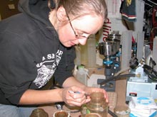 Research technician, Sarah Thornton, places a new filter on a filter unit.