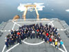 The science team and Healy crewmembers pose for a group picture on the Healy's helo deck.