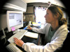 Andrea Quattrini monitors sonar data while the team assesses a potential dive site.