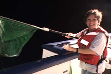 Reneé Green and a specimen of halfbeak she caught during a nightlighting session.