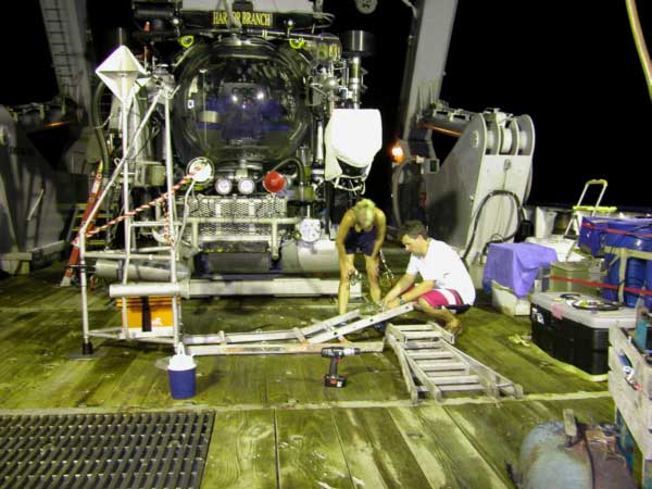 Graduate student Erika Raymond and visiting scientist, Justin Marshall, begin to devise the CLAM Cannibalized Ladder Alignment Mechanism.