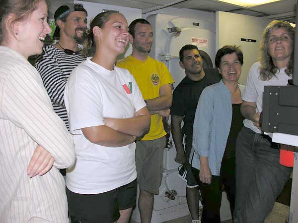 The exuberant science crew watching video footage of the chain cat shark