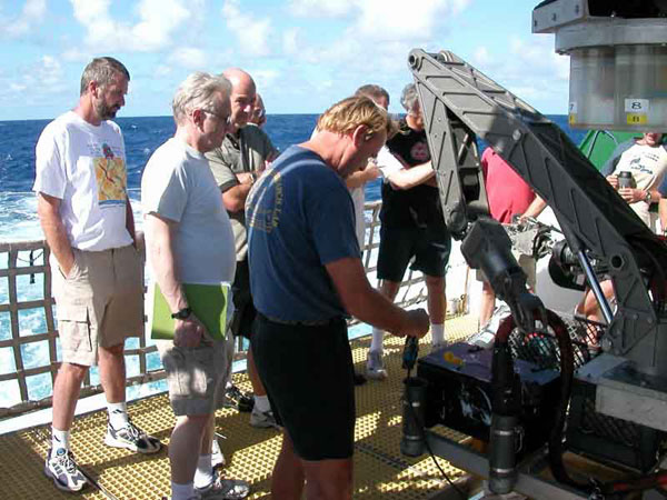 Terry Kerby shows the scientific party the sampling basket arrangement on the front of the sub.