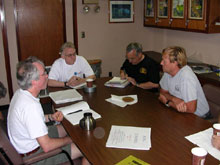 Dave Butterfield, Bob Embley, Gary Massoth, and Terry Kerby (chief Pisces pilot) discuss the hazards of diving on Monowai, an active submarine volcano.