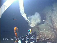 Pisces V stops to collect a rock sample from an outcrop of pillow lava.