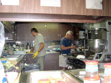 The galley crew of the K-o-K hard at work preparing and serving three meals a day.