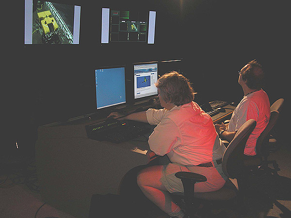 Deborah Kelley and Jeff Karson work at the Science Control Center