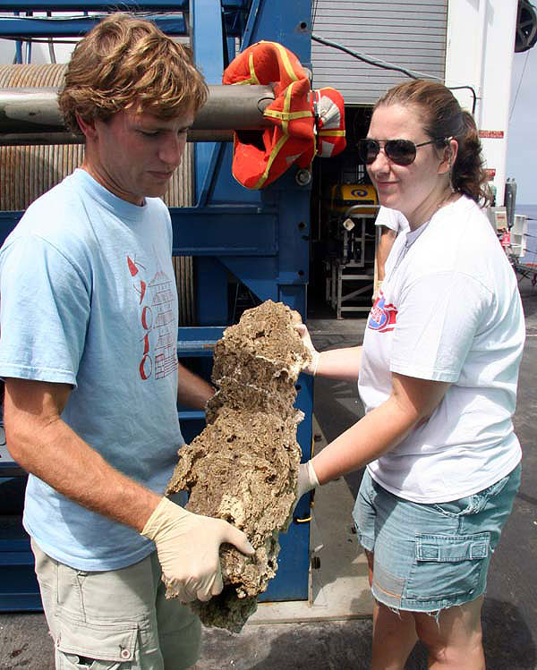 Giora and Kate carry a meter-long carbonate collected during the first dive