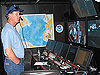 Dr. Ballard stands in the Ship's Control Room