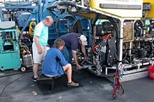 Timothy Shank of the Woods Hole Oceanographic  Institution, David Lovalvo of the Institute for Exploration (IFE),  and David Wright of IFE work on modifications to the ROV Hercules.