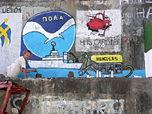 NOAA Ship Ronald H. Brown Chief Boatswain Bruce Cowden putting the finishing touches on a painting at the port in Ponta Delgada.