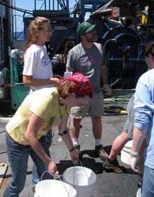 Sarah L'Heureux of the Woods Hole Oceanographic Institution participates in the 'bucket brigade'.