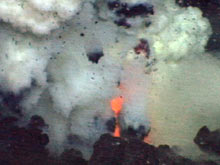 Glowing red lava jetting out of the vent at Brimstone Pit.