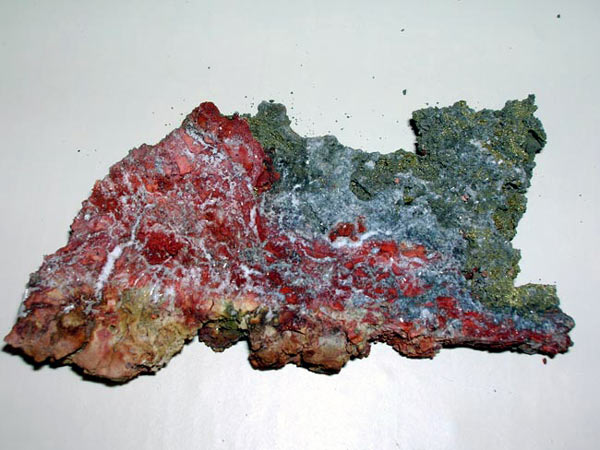 Striking example of the iron oxide mineral hematite intergrown with barite and chalcopyrite.