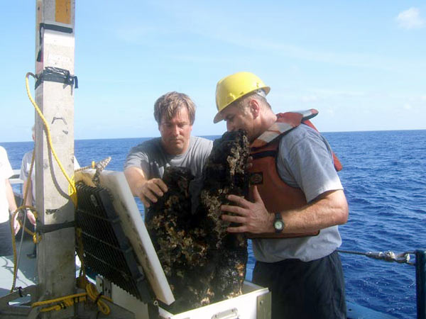 Scientist remove a huge, extinct sulfide sample from the elevator, after its trip from the seafloor to the surface.
