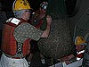 Bob Carney and Matt Kupchik cautiously place a cooler to contain the trawl's muddy catch.