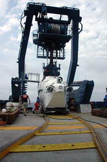 The ALVIN submersible is rolled out of its hangar and back to the ATLANTIS fantail along a special curved railroad track.