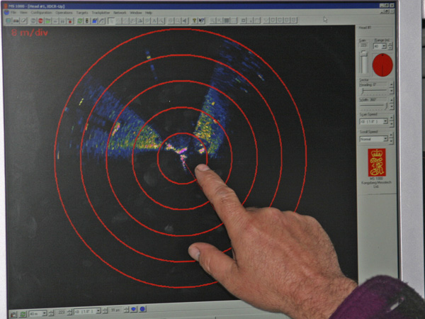 Monitor screen from the ROV sonar showing a red target area, indicating a large hard object.