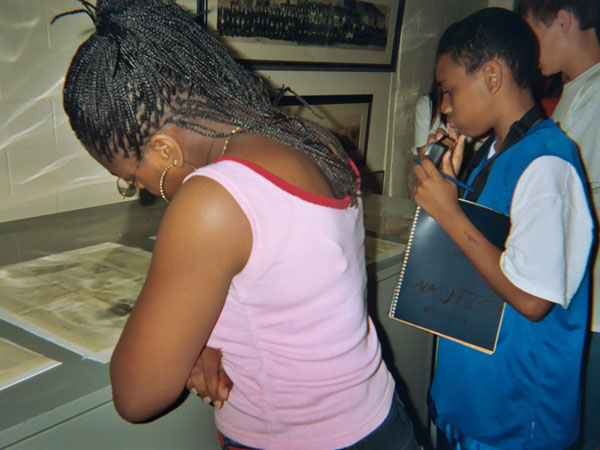 Joseph and Brandon laugh as they analyze artifacts from the USS Cumberland