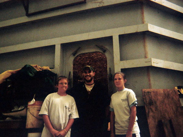 Jacob and Marena pose with one of the conservators who working on the Monitor's Turret