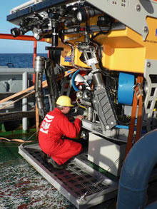 View of the front of the ROV, which consists of propellers, hydraulic pumps and lots of cameras, lights and electronics, as well as two arms.