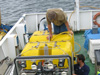 Joe Caba and Toshi Mikagawa connect the Global Explorer ROV to its yellow tether.