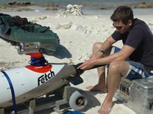 Preparing to launch scientist attach the nose of the Fetch AUV which contains the side scan sonar, some water quality sensors, and the color video camera.