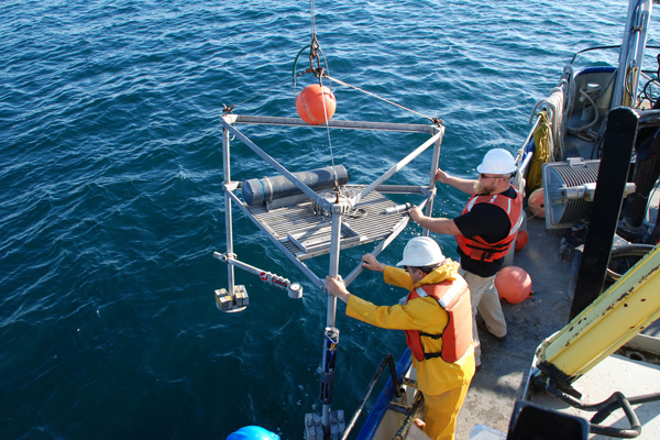 Nathan Hawley and Steve Constant prepare to deploy a tripod near the Middle Island Sinkhole 