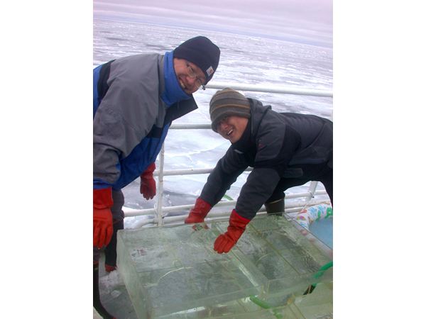 At the northernmost station of the 2009 RUSALCA expedition, Sang Lee and Hyoung Min Joo check that the open-air water baths, where phytoplankton incubate in bottles, are not frozen solid.