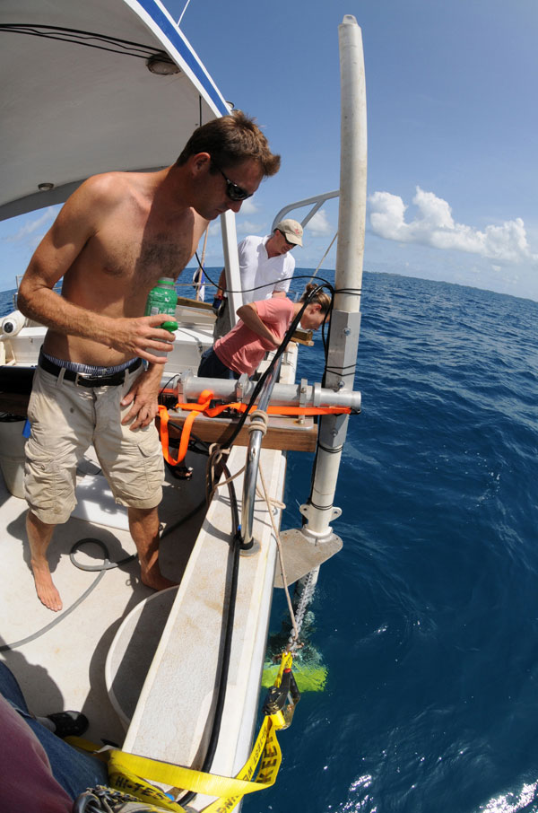 Multibeam sonar transducers deployed at the end of a pole secured alongside the boat.