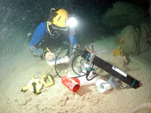 Cave diver Brian Kakuk places a Doppler current meter in a submarine cave. 