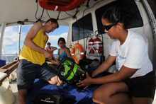 Todd Hallenbeck, Krystle Gomez and Alexis Hall, work together to prepare the ROV for launch and exploration.