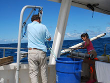Dr. Kvitek and Krystle Gomez work together to position the acoustic transducer off the side of the boat. This transducer works with a GPS to track the exact position of the ROV on its dives.
